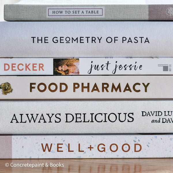 stack of cookbooks for decorating kitchen. White and blush kitchen decor. 