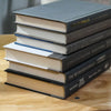 Set of used books with gray binding for home display and decoration.