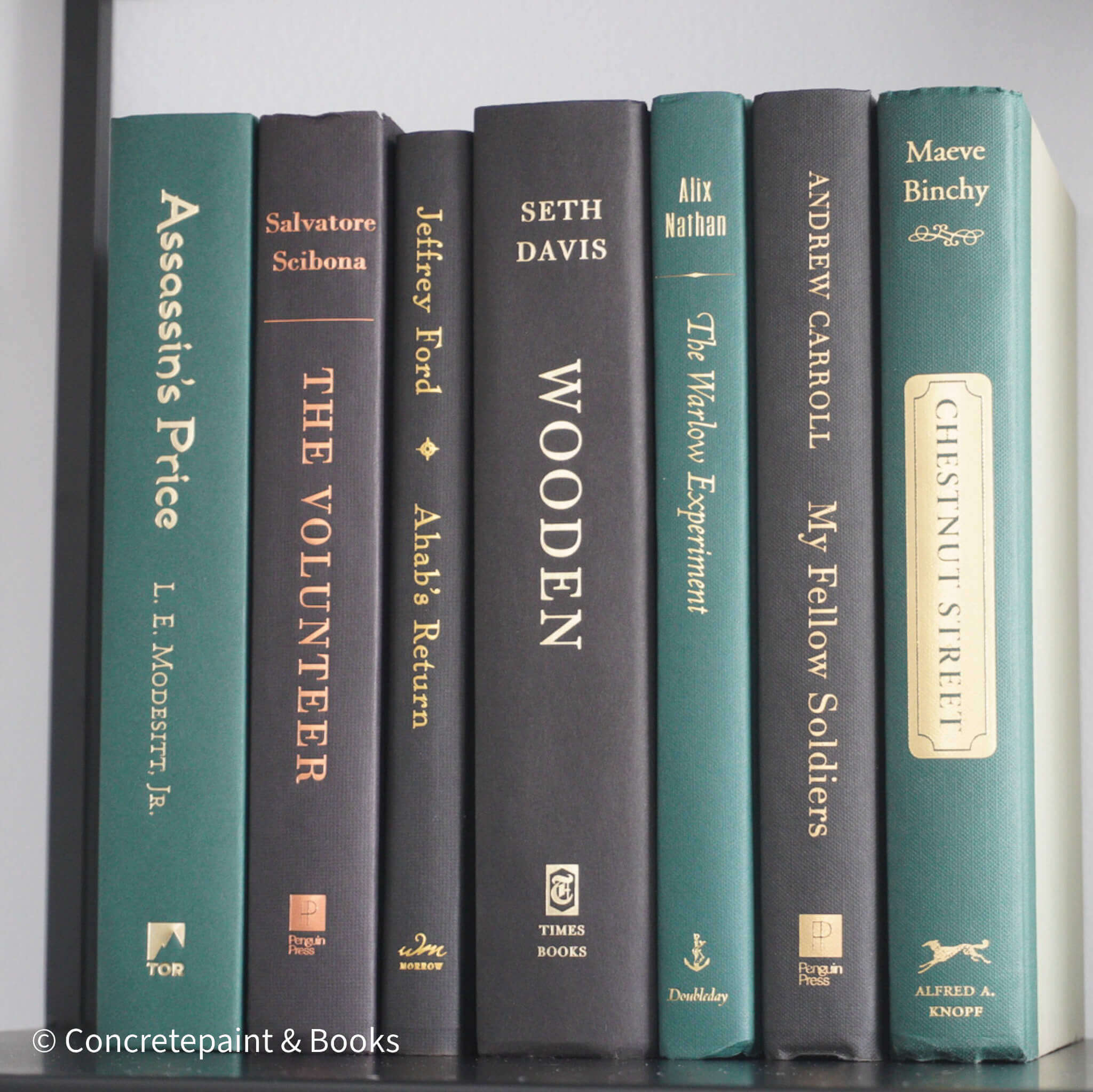 Set of green and black hardcover books used for decorating. Book desplay used for men's shelf decor.
