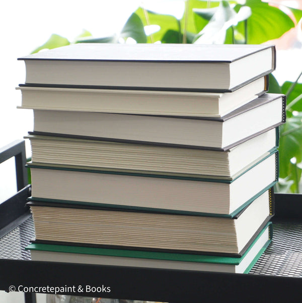 Set of green and black hardcover books used for decorating. Book desplay used for men's shelf decor.