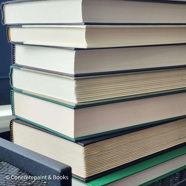 Set of green and black hardcover books used for decorating. Book desplay used for men's shelf decor.