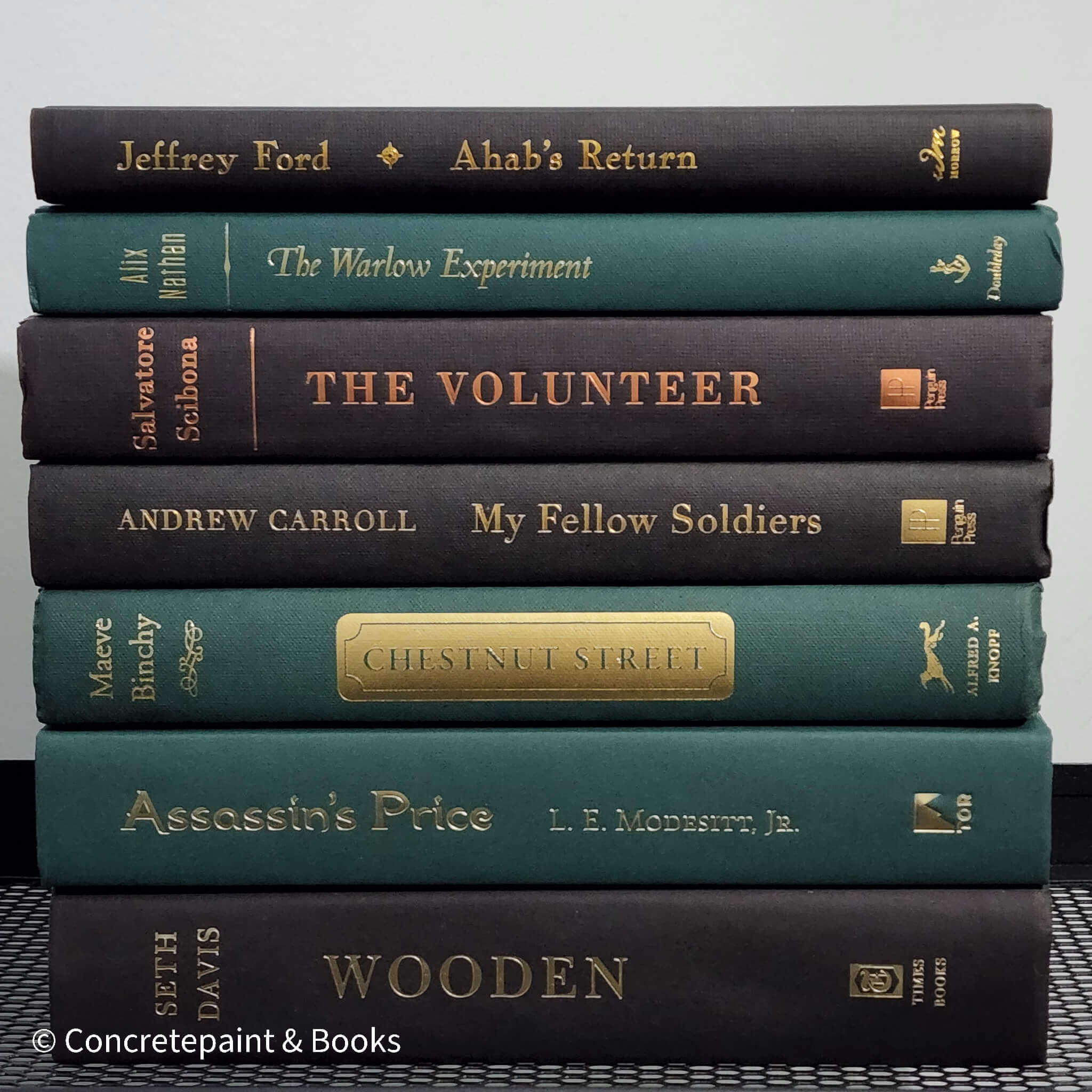 Set of green and black hardcover books used for decorating. Book desplay used for men's shelf decor.