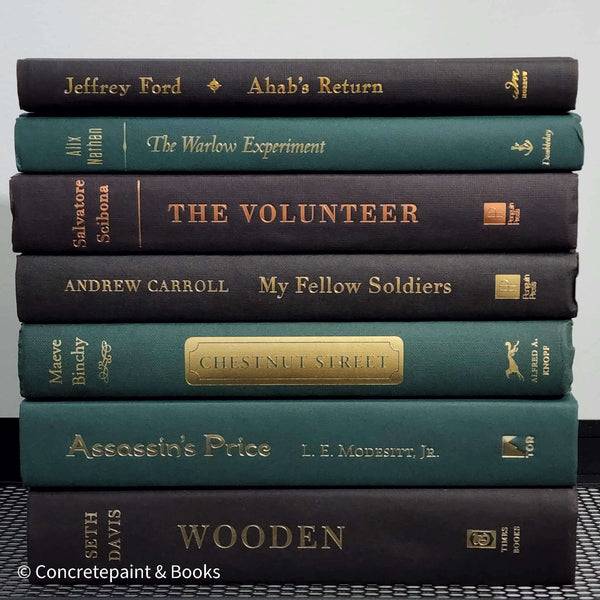 Set of green and black hardcover books used for decorating. Book desplay used for men's shelf decor.
