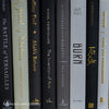 Black gray white and neutral books on display. Stack of decorative books.