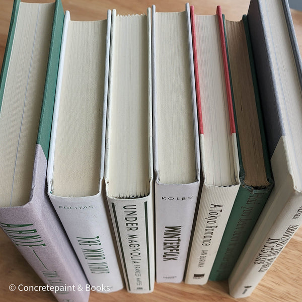 Green neutral and gray real hardcover book stack used for decoration.