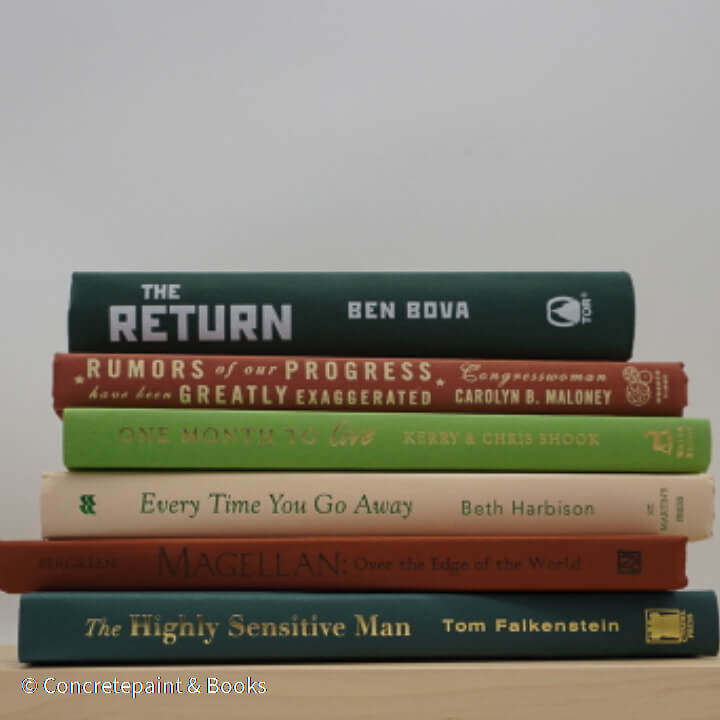 Real books as display on shelf. Hardcover green, neutral, and terra cotta color.