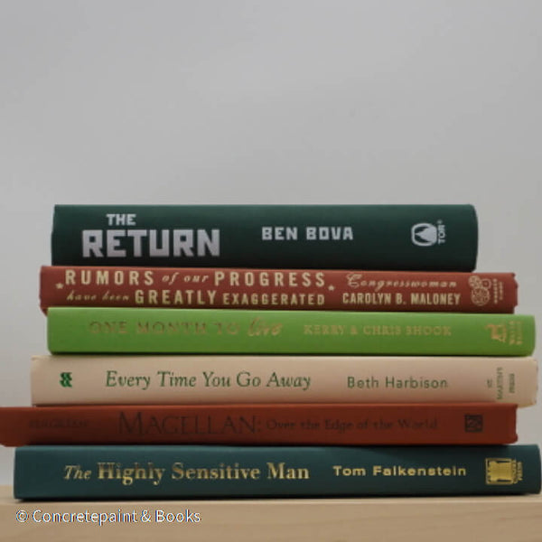Real books as display on shelf. Hardcover green, neutral, and terra cotta color.