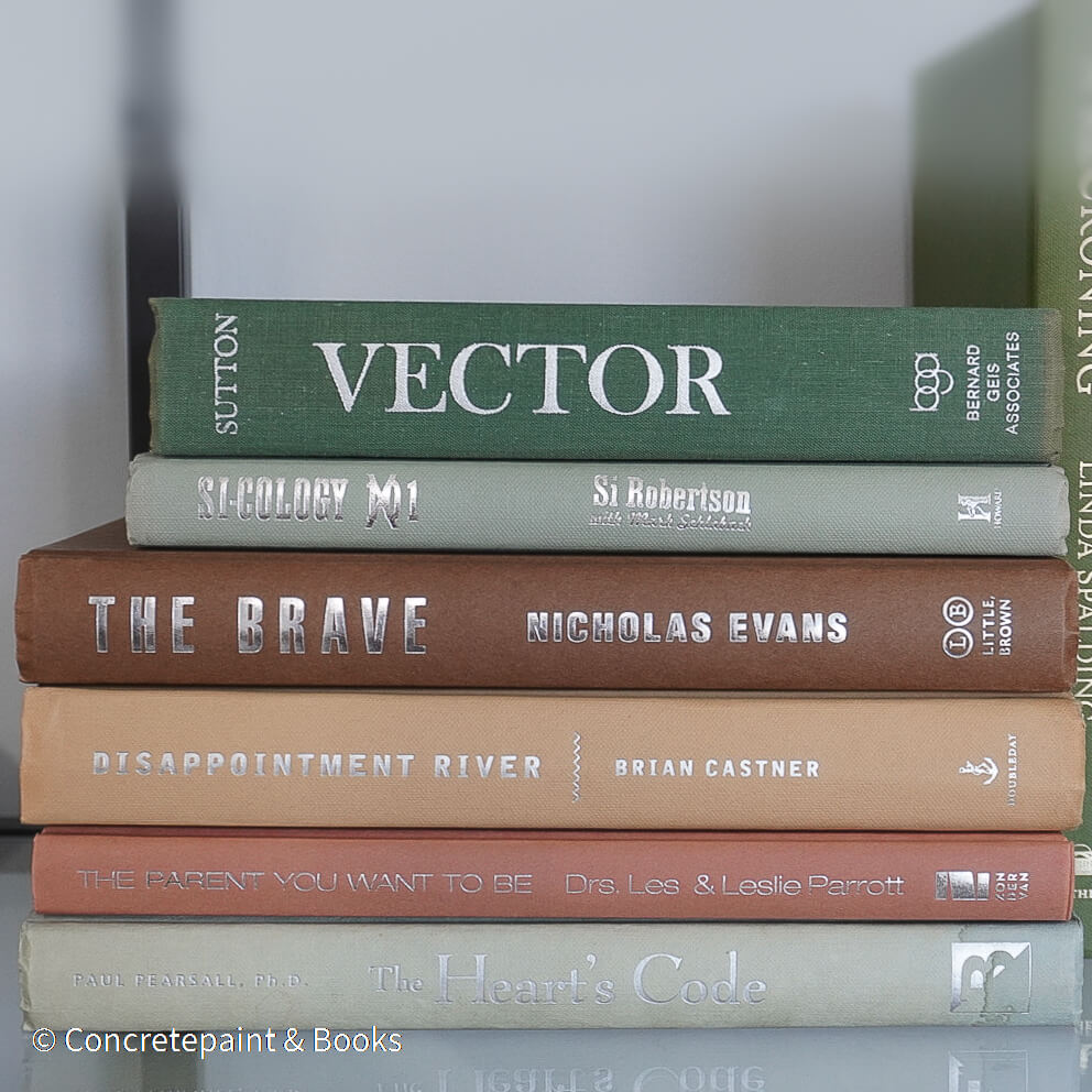 Green and brown books used for shelf decor. 