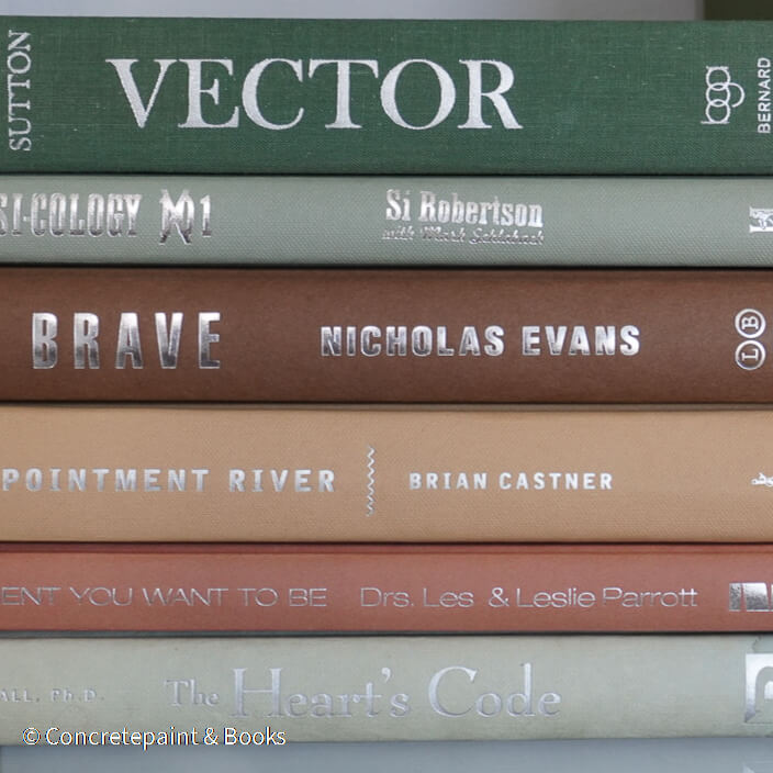 Green and brown books used for shelf decor. 