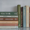 Green and brown books used for shelf decor. 
