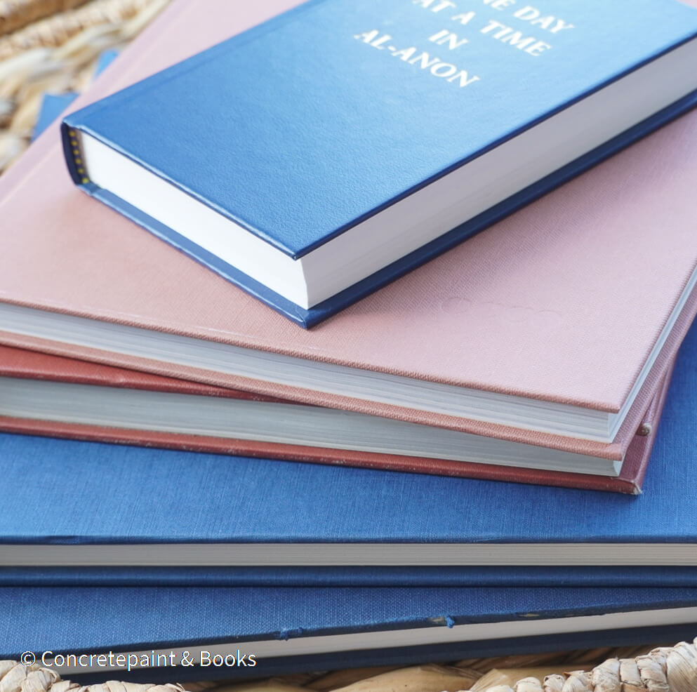 Navy blue and terra-cotta colored books. Decorative books for display. 