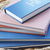 Navy blue and terra-cotta colored books. Decorative books for display. 