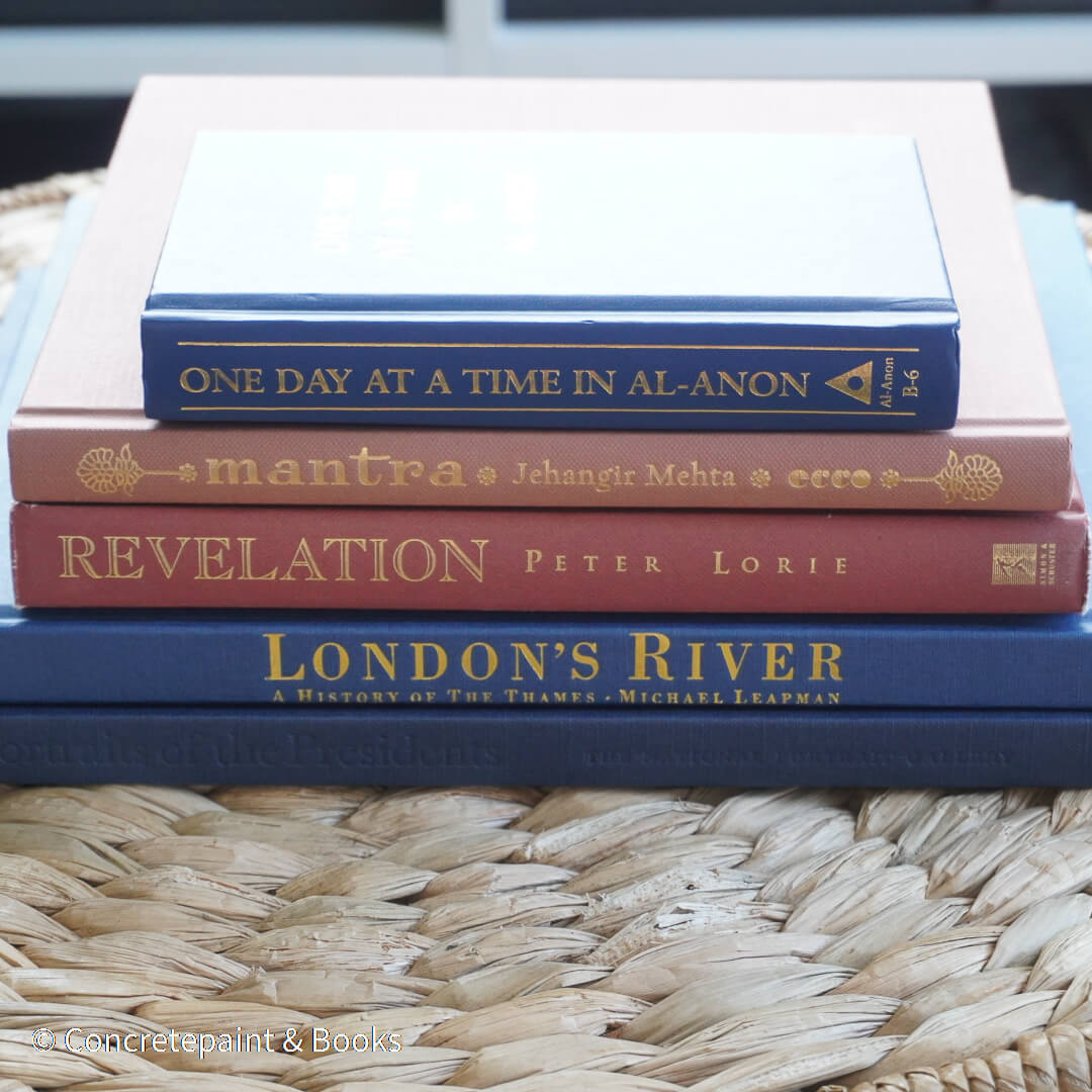 Navy blue and terra-cotta colored books. Decorative books for display. 