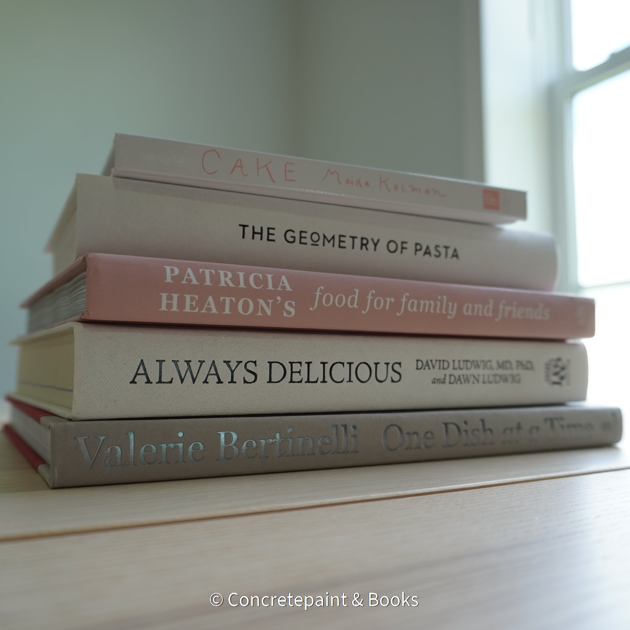 Stack of hardcover books used to decorate. Blush and neutral display books.