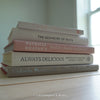 Stack of hardcover books used to decorate. Blush and neutral display books.