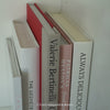 Stack of hardcover books used to decorate. Blush and neutral display books.