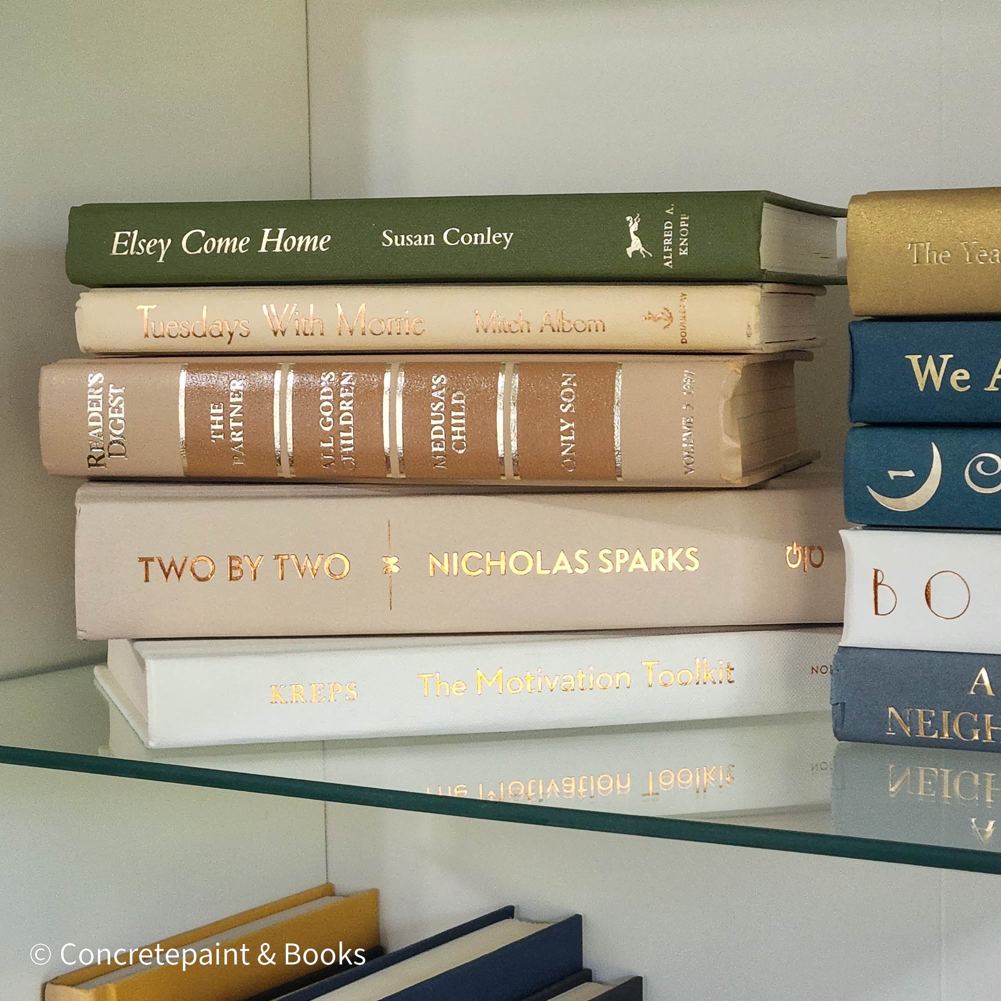 Olive green and neutral books used as shelf decor. Set of books for reading and decorating.