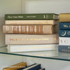 Olive green and neutral books used as shelf decor. Set of books for reading and decorating.