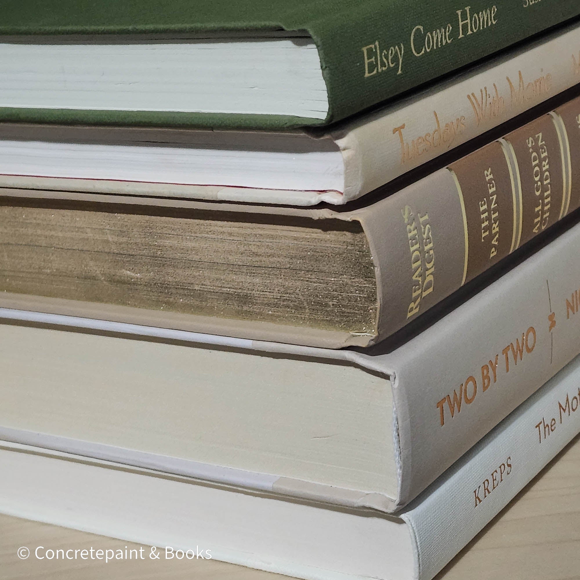 Olive green and neutral books used as shelf decor. Set of books for reading and decorating.