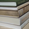 Olive green and neutral books used as shelf decor. Set of books for reading and decorating.