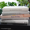 Set of decorative books for display. Real hardcover books in white, blush, and silver purple used for decorating. Decorative cookbook, cocktail book, and coffee table book.