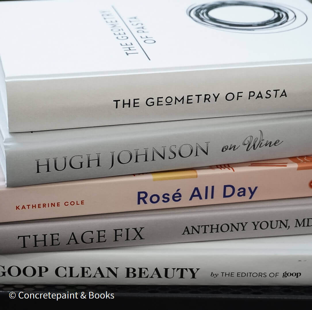 Set of decorative books for display. Real hardcover books in white, blush, and silver purple used for decorating. Decorative cookbook, cocktail book, and coffee table book.