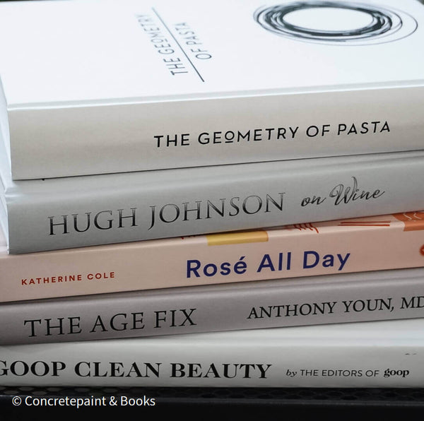 Set of decorative books for display. Real hardcover books in white, blush, and silver purple used for decorating. Decorative cookbook, cocktail book, and coffee table book.