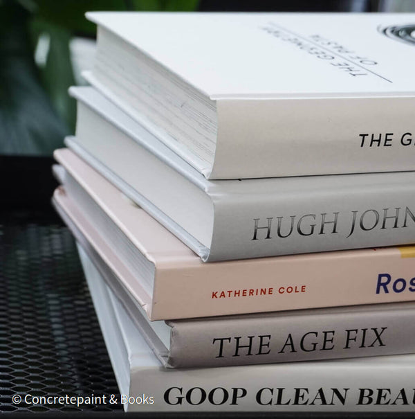 Set of decorative books for display. Real hardcover books in white, blush, and silver purple used for decorating. Decorative cookbook, cocktail book, and coffee table book.