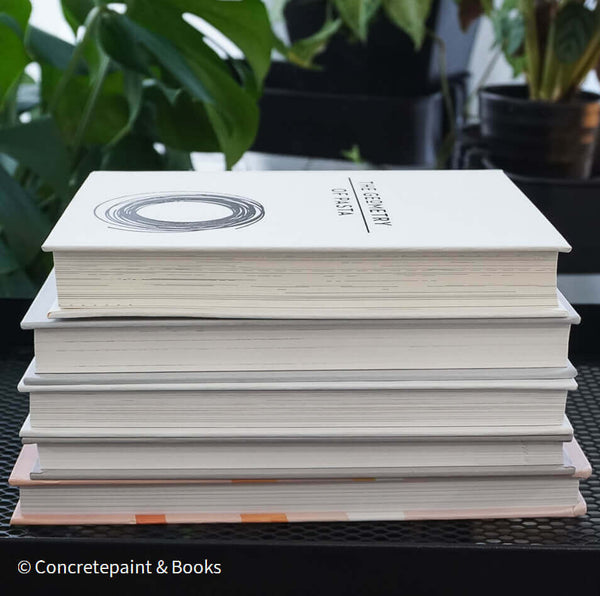 Set of decorative books for display. Real hardcover books in white, blush, and silver purple used for decorating. Decorative cookbook, cocktail book, and coffee table book.