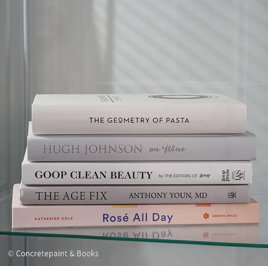 Set of decorative books for display. Real hardcover books in white, blush, and silver purple used for decorating. Decorative cookbook, cocktail book, and coffee table book.