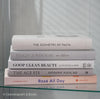 Set of decorative books for display. Real hardcover books in white, blush, and silver purple used for decorating. Decorative cookbook, cocktail book, and coffee table book.