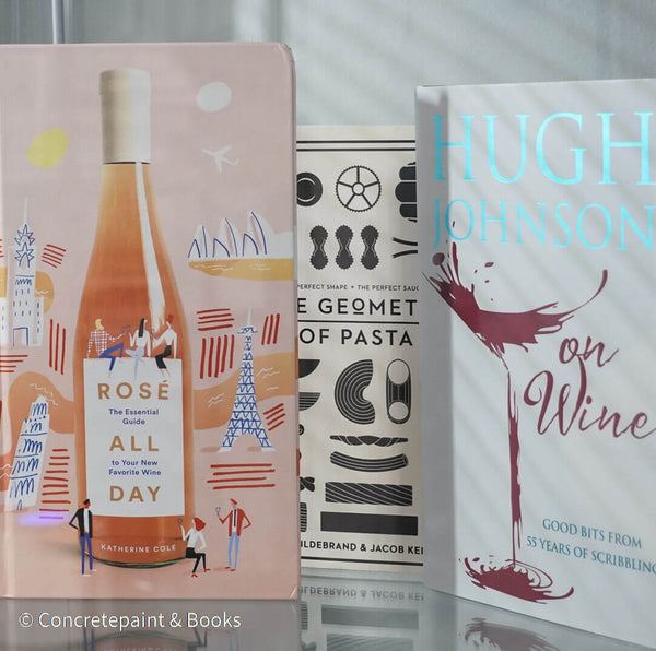 Set of decorative books for display. Real hardcover books in white, blush, and silver purple used for decorating. Decorative cookbook, cocktail book, and coffee table book.