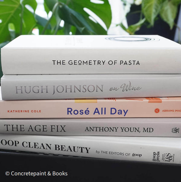 Set of decorative books for display. Real hardcover books in white, blush, and silver purple used for decorating. Decorative cookbook, cocktail book, and coffee table book.