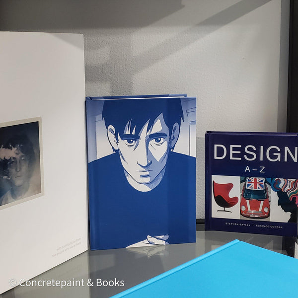 Stack of white and blue hardcover coffee table books. 