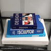 Stack of white and blue hardcover coffee table books.  