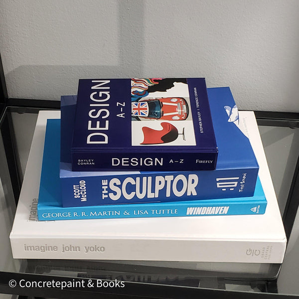Stack of white and blue hardcover coffee table books.  